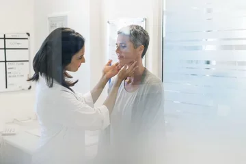 A female doctor checks on a female patient