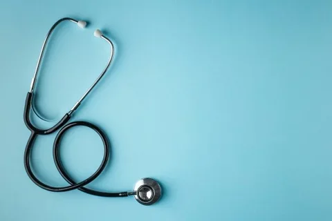 Black stethoscope on blue background