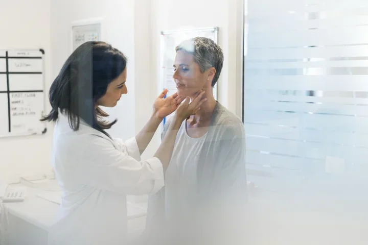 A female doctor checks on a female patient