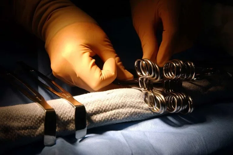 Surgeon hands on tools