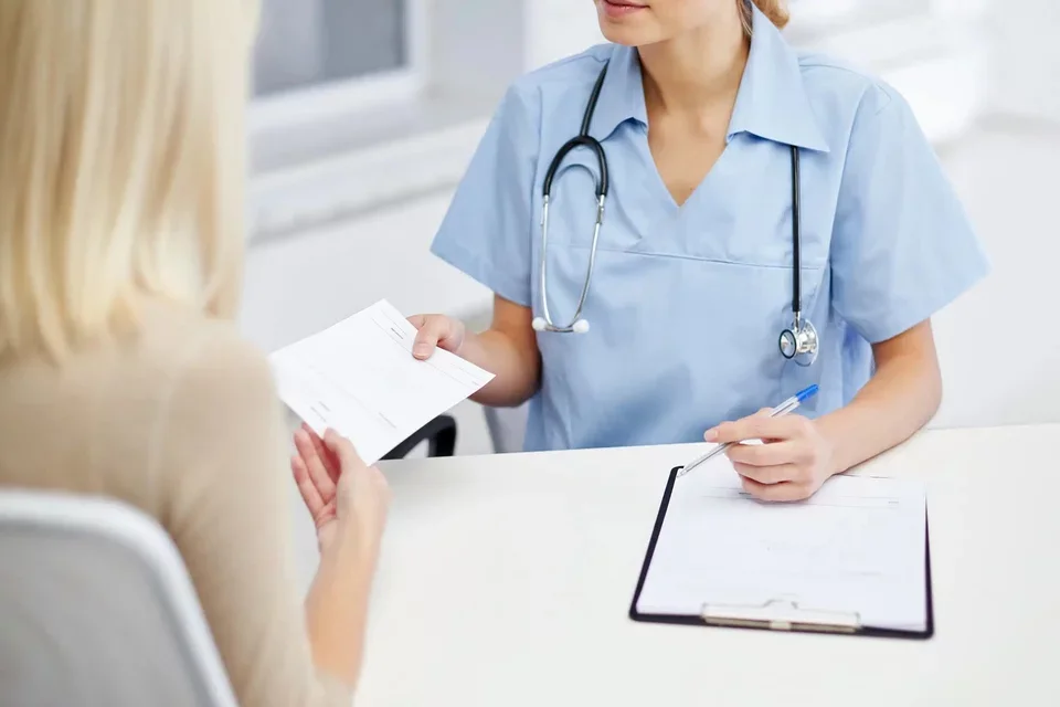 Doctor handing patient note