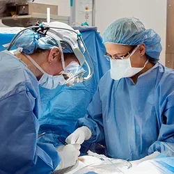 Two surgeons performing surgery in the operating room.