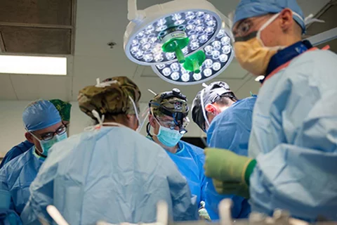 FIve surgeons in the operating room during surgery